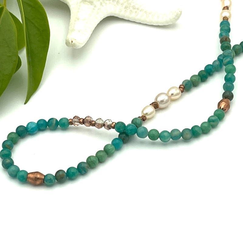 Close up showing faceted shape and dainty size of Amazonite gemstone necklace.